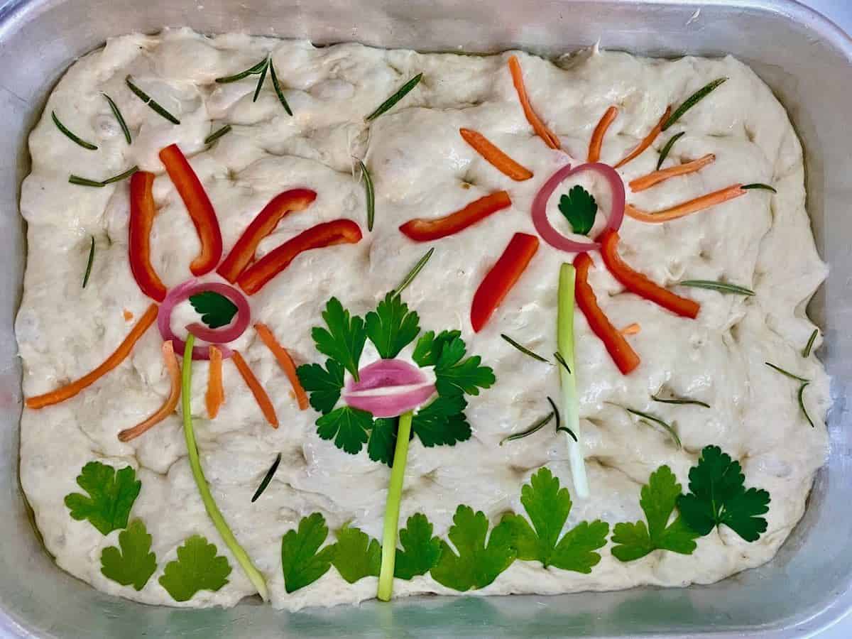 Family fun focaccia art created by my granddaughter. She created a lovely garden.