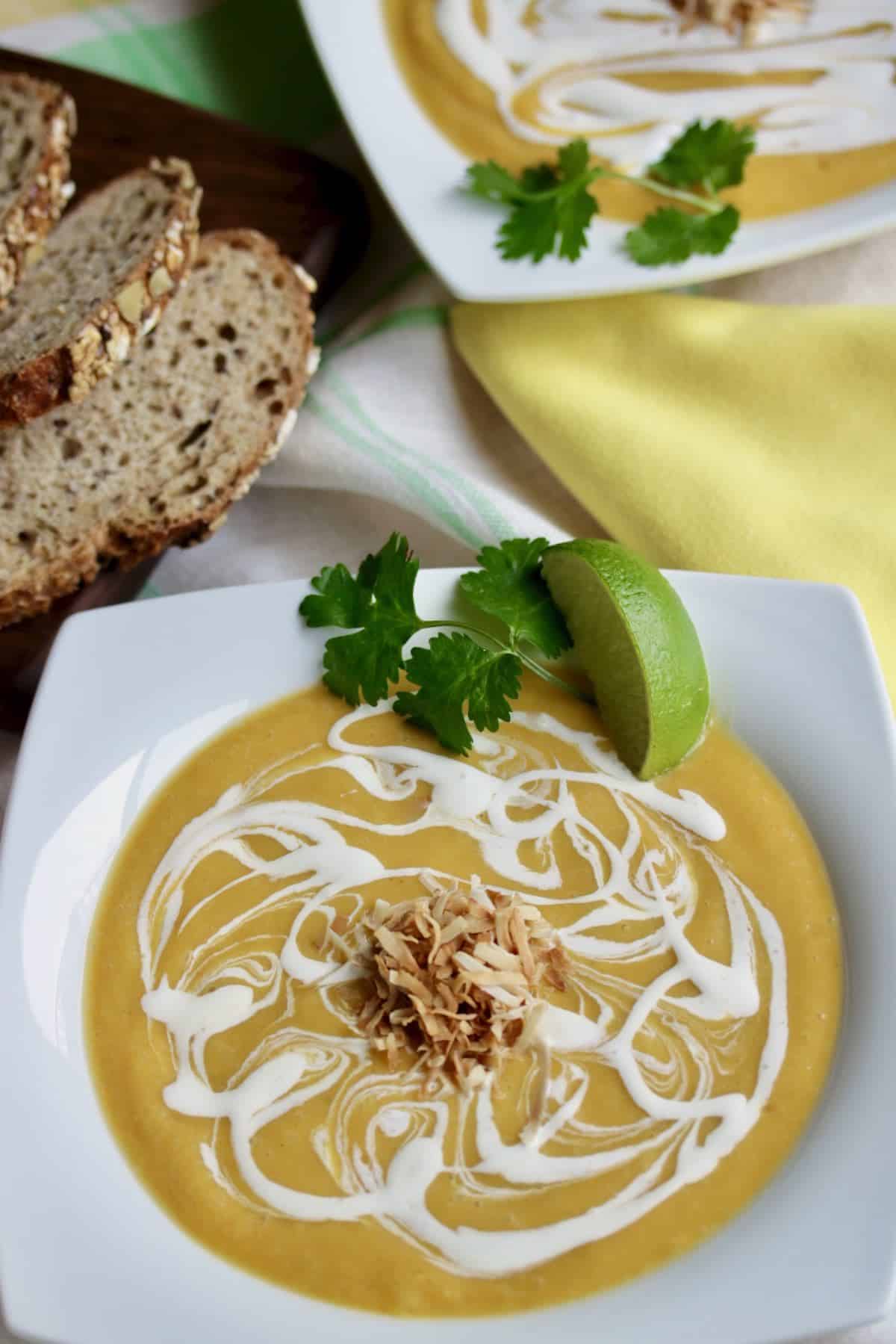 Tropical Butternut Squash Soup with slices of bread.