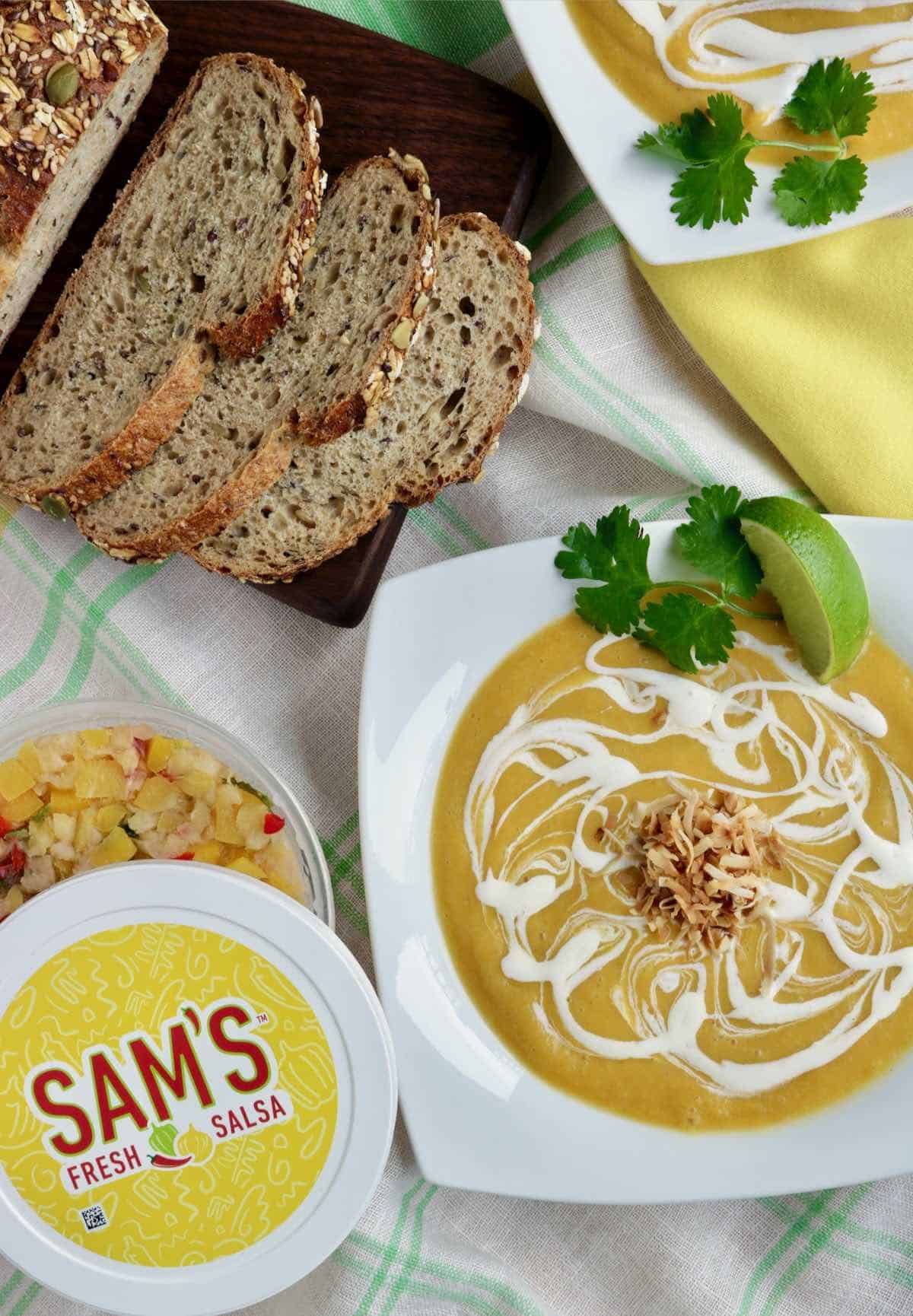 Sam's Fresh Salsa and a bowl of soup and sliced bread.