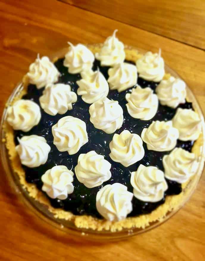 Meringue kissed lemon pudding pie with wild berry jam.
