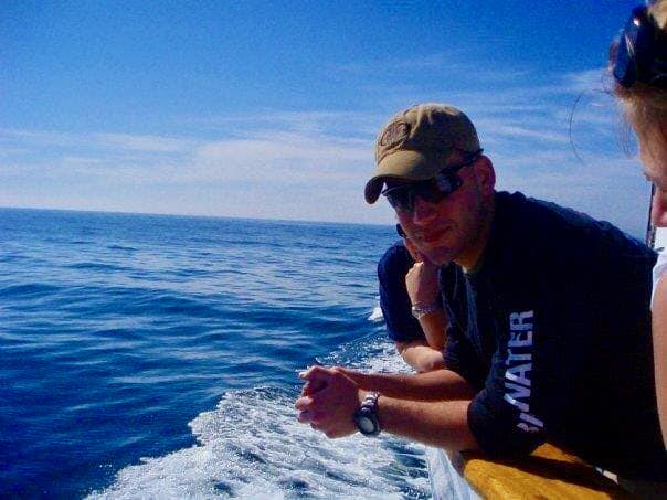 My son on a boat at the beach.