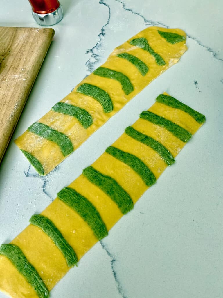 Rolled out green and white dough.