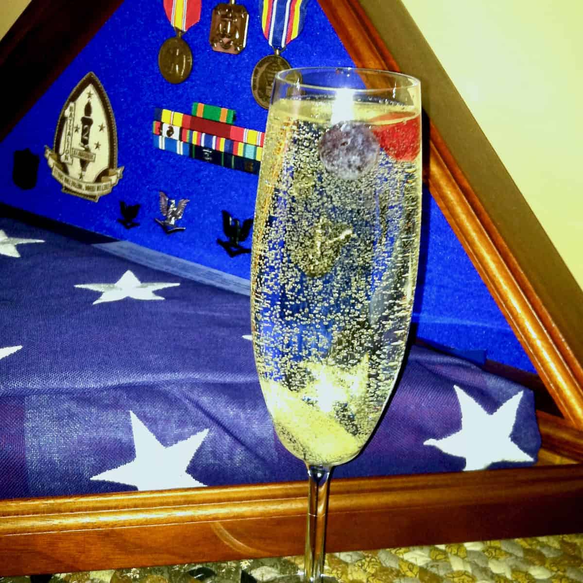 His memorial flag, medals and a sparkling cocktail.