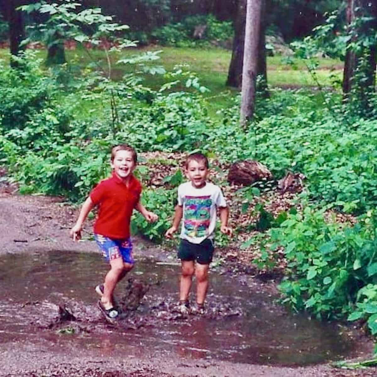 Will and friend playing in a mud puddle.