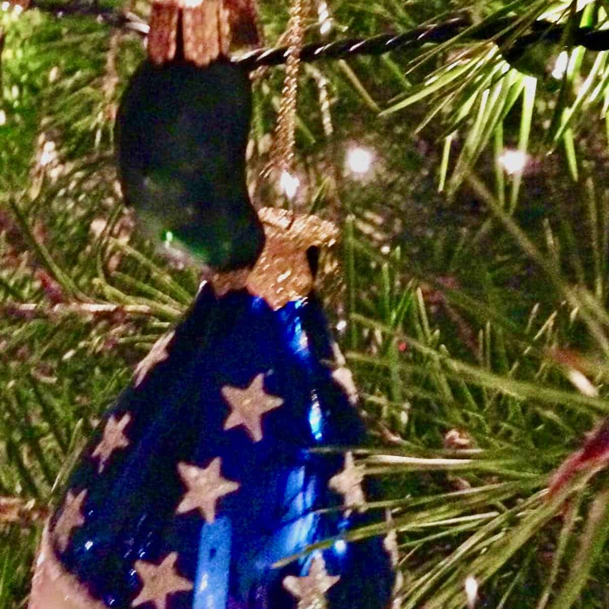 Pickle and American flag xmas ornaments on tree.