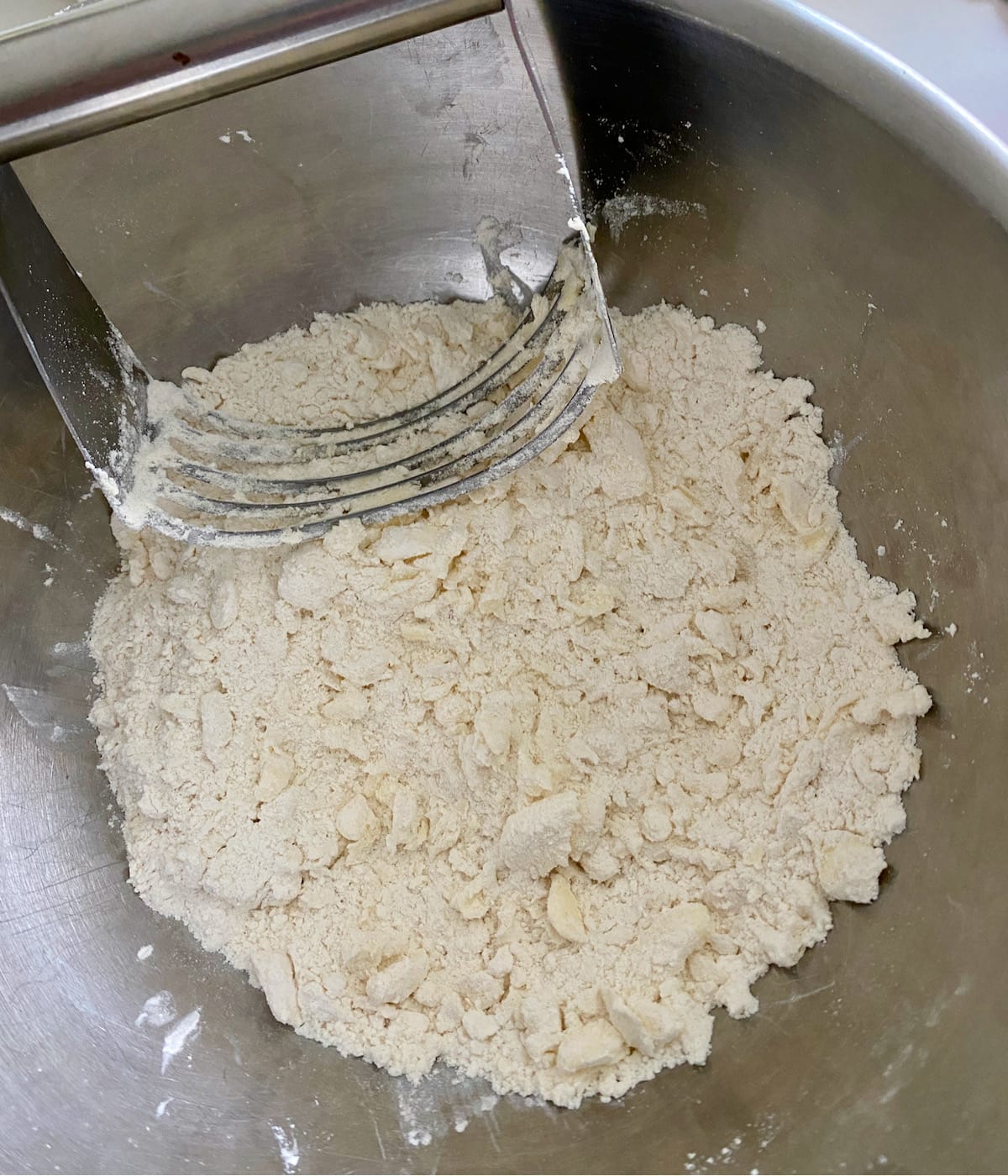 Using a pastry blender to cut in the butter.