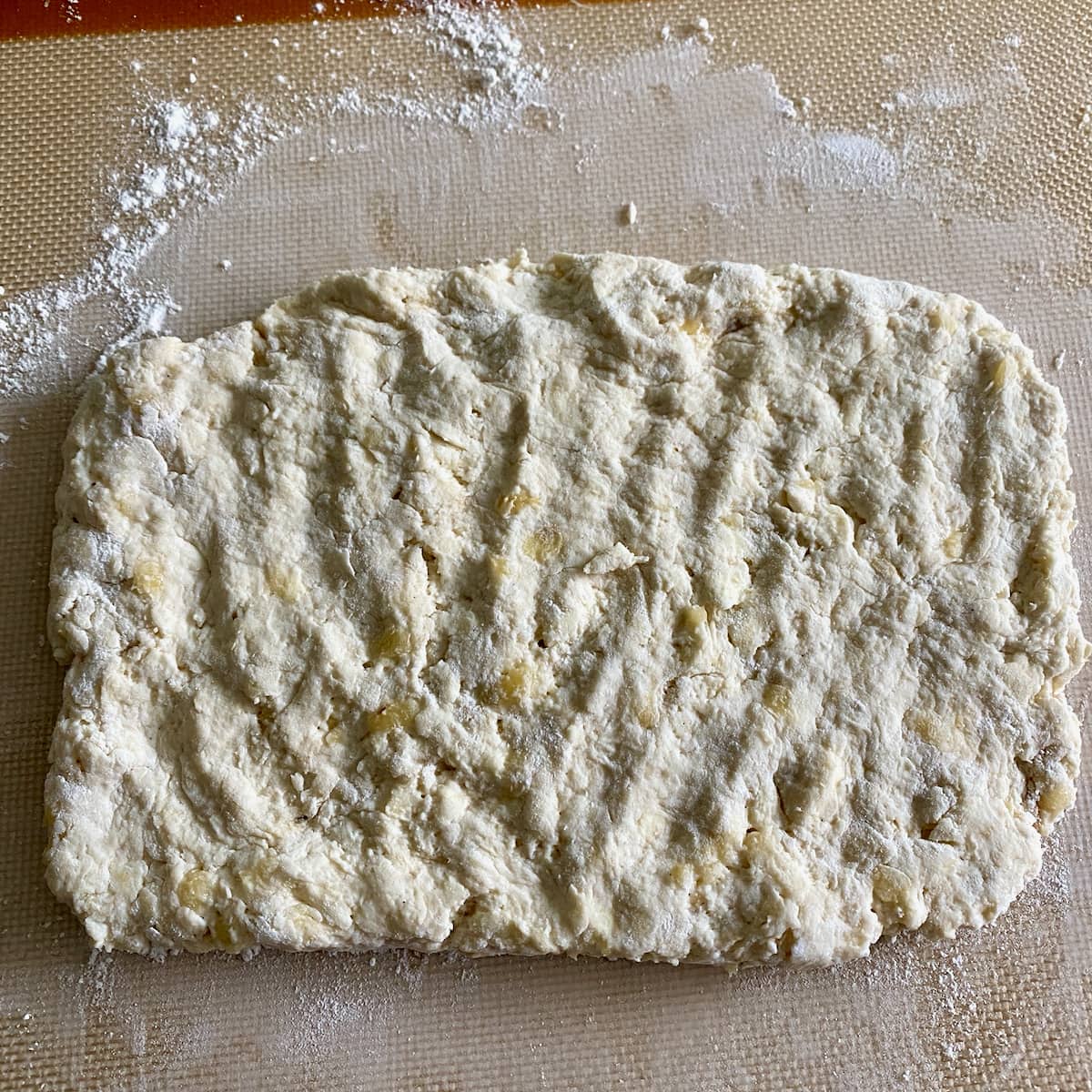 Patting the dough into a rectangle.