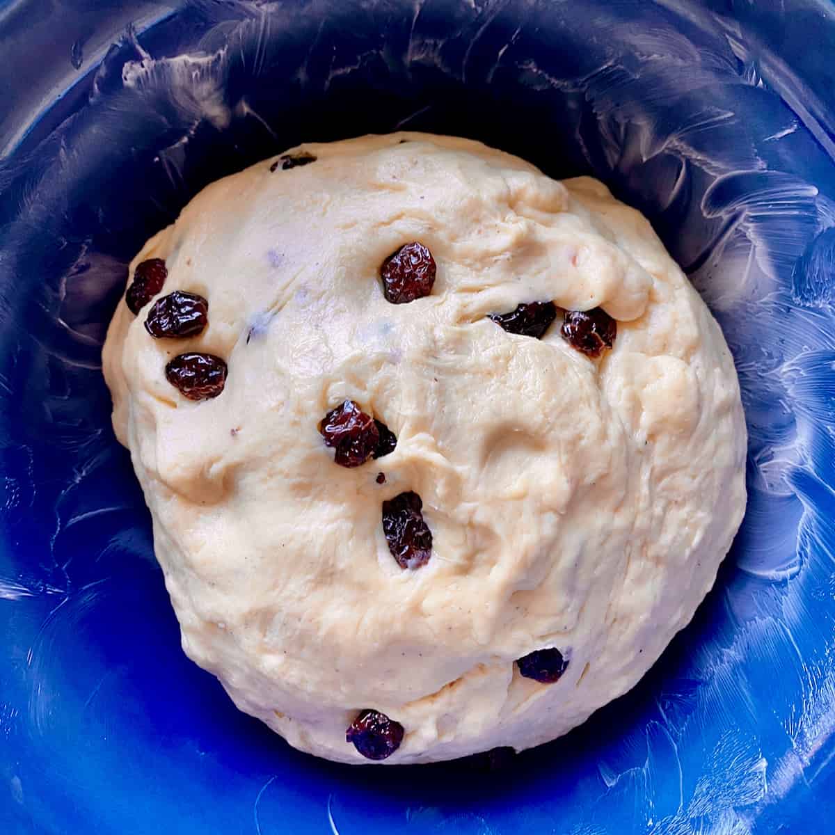 Smokehouse cranberry cheese bread dough in a blue bowl.