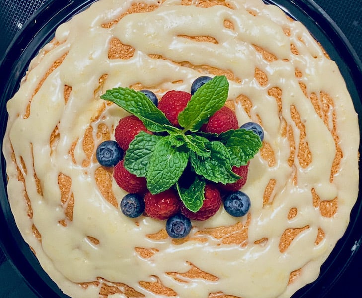 Homemade angel food cake with lemon ganache and fresh berries.