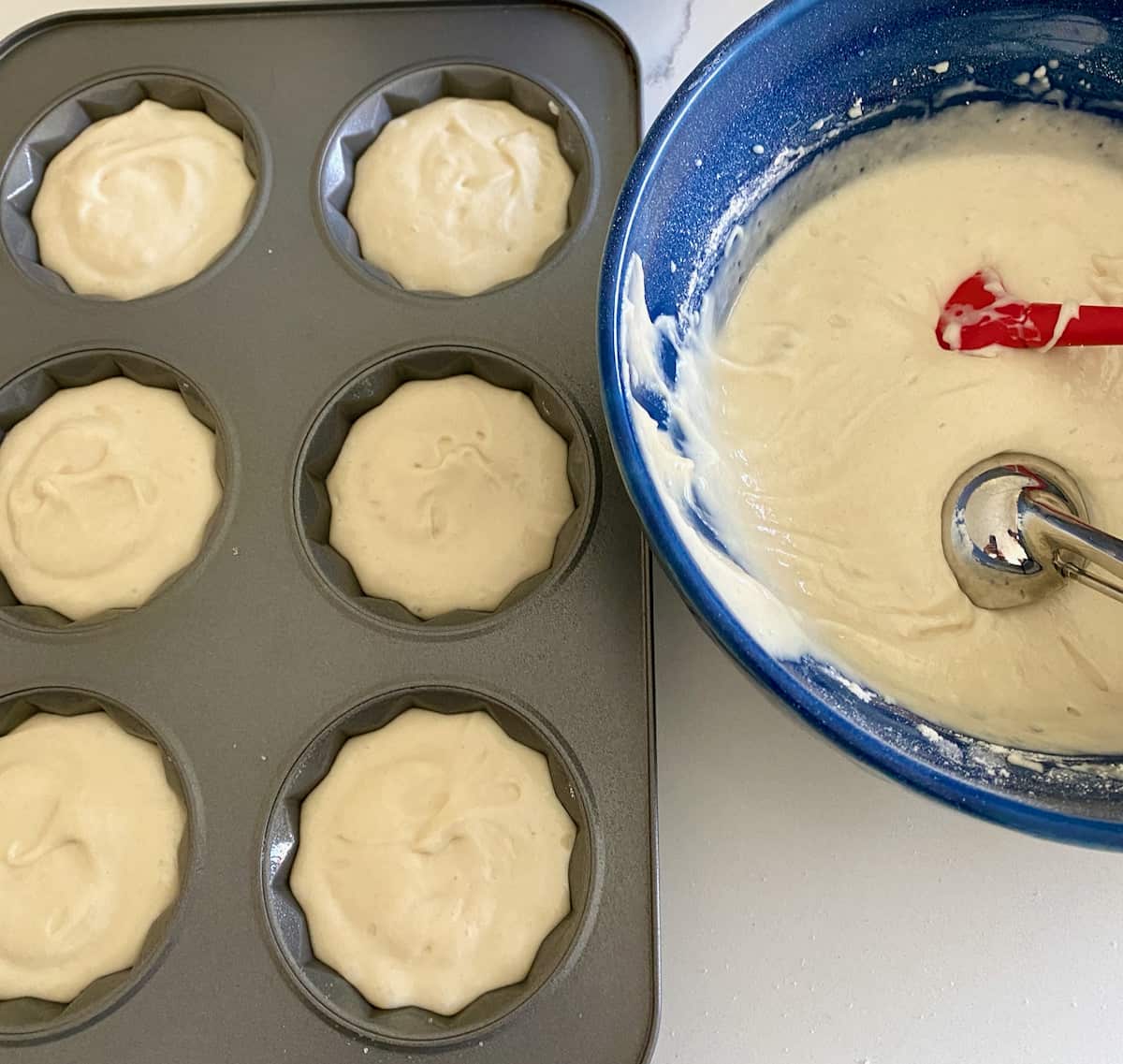 Pineapple upside down cakes batter in mini bundt pan.