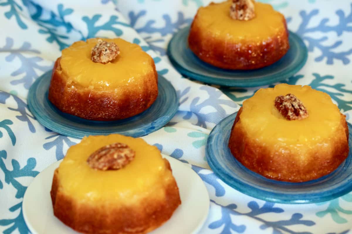 Mini pineapple upside down cakes with candied pecans.