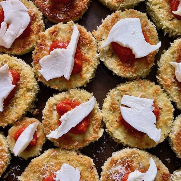 Freshly torn mozzarella on fried eggplant.