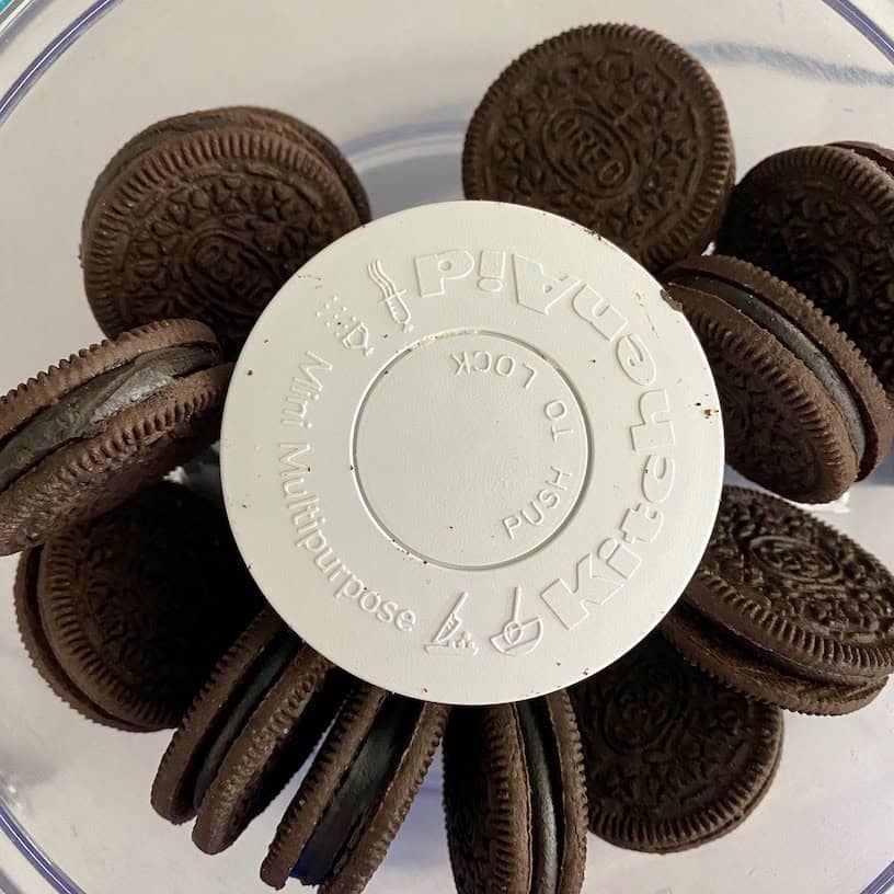 Dark chocolate Oreo cookies in food processor.
