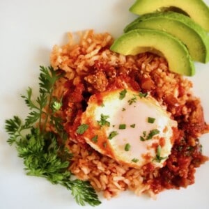 Mexican eggs in purgatory with rice and avocado.