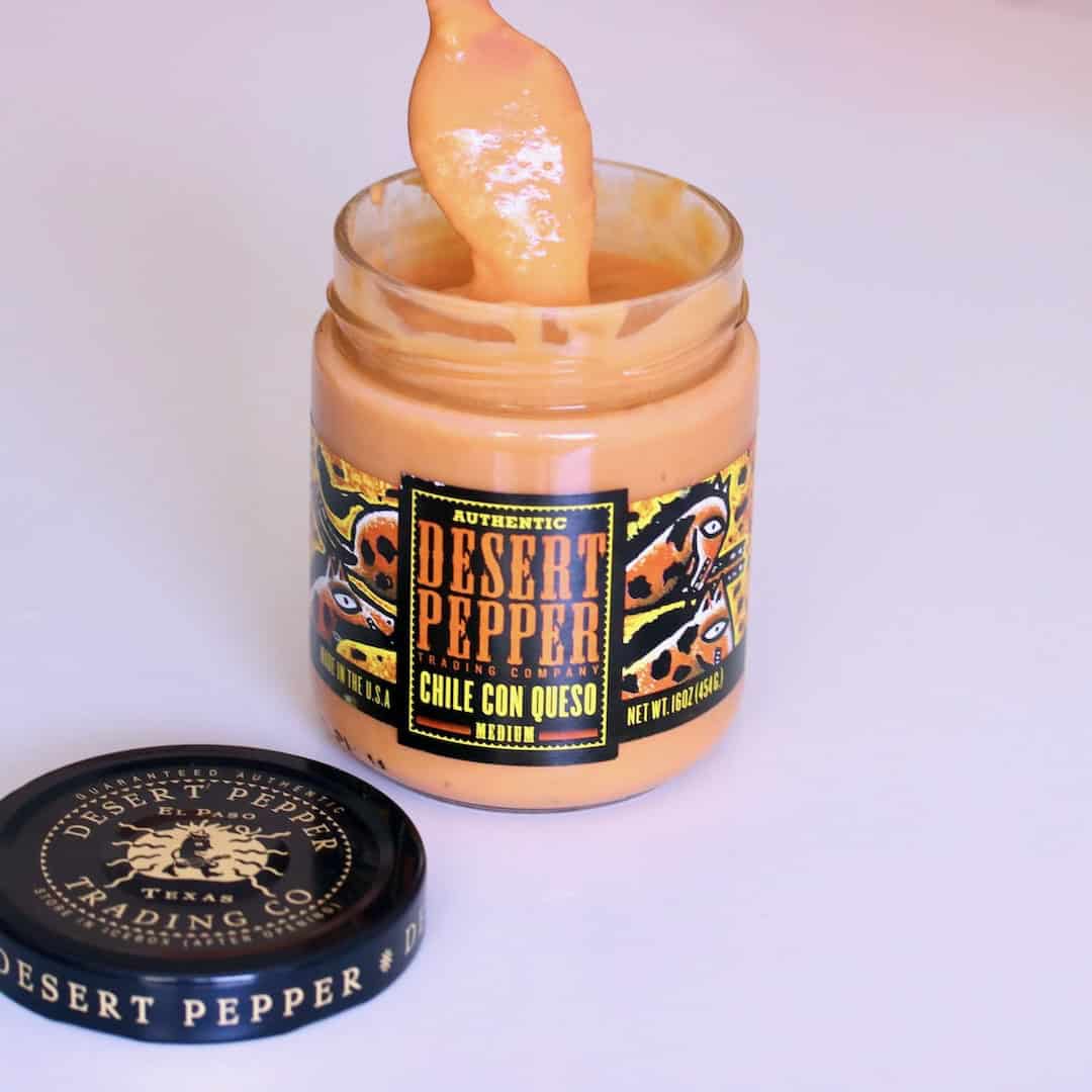Open jar of chile con queso.