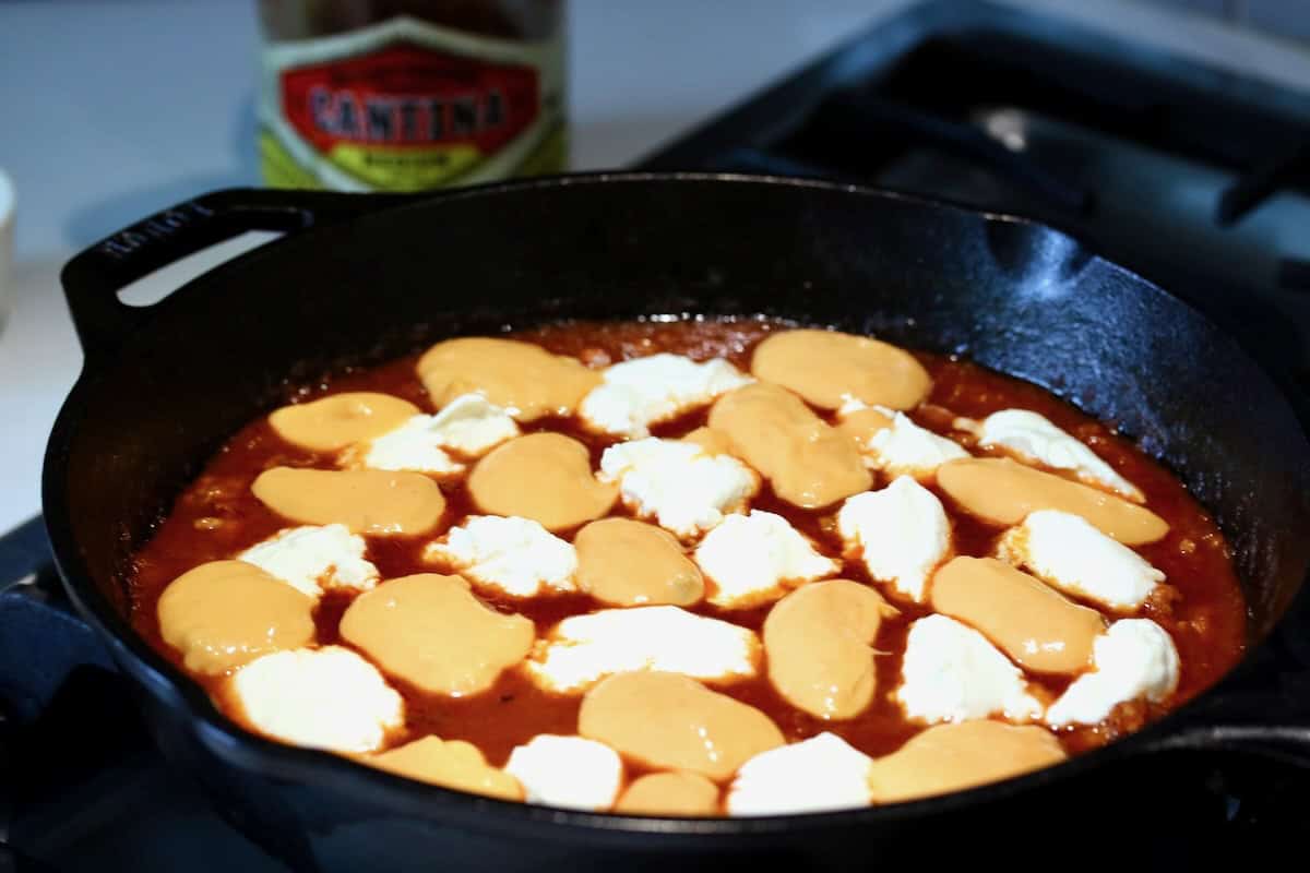 Layers of queso and ricotta on the dip.