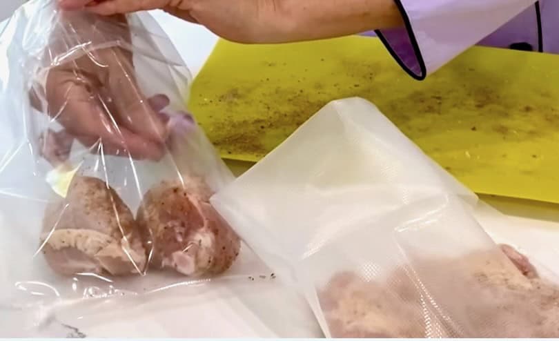 Preparing chicken in sous vide bags.