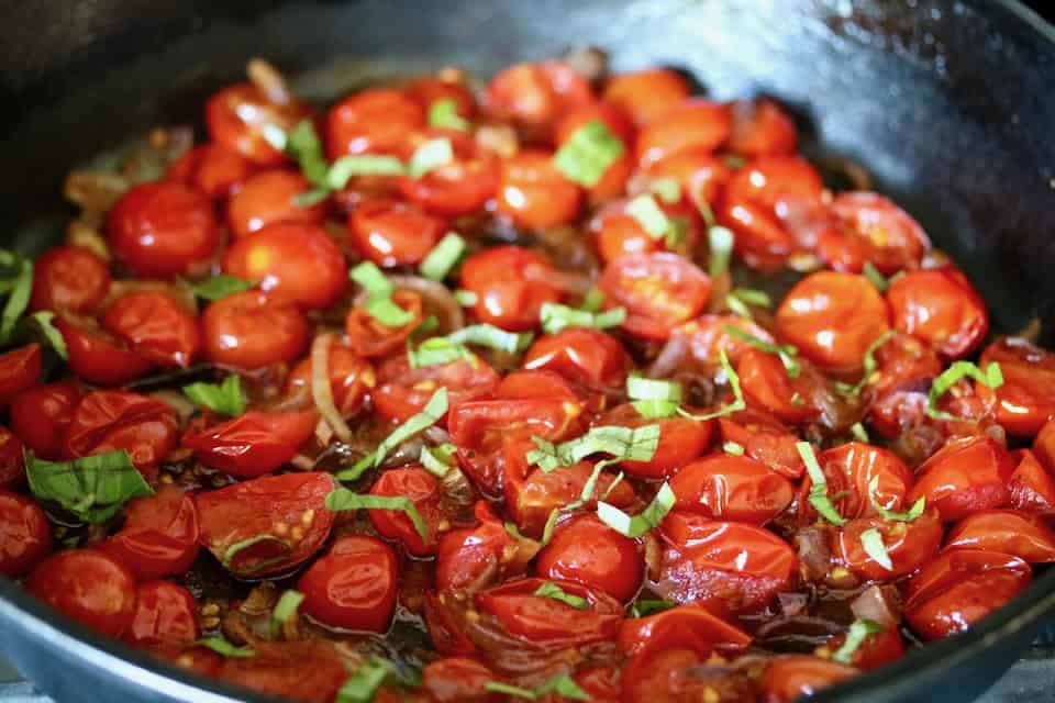 Cooked tomatoes, shallots and basil.