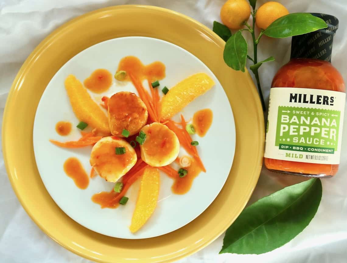 Pan seared scallops with a spicy citrus sauce.