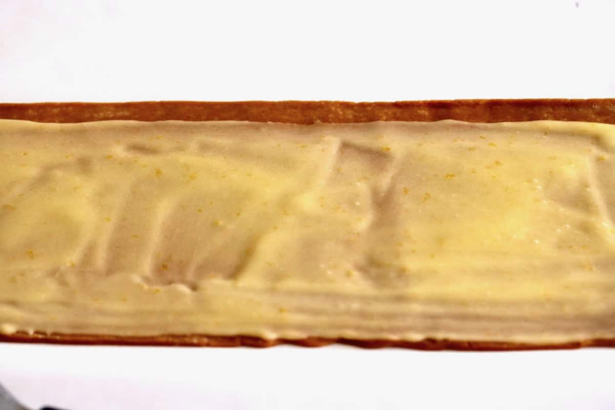 Spread a thin layer of filling over cookie dough.