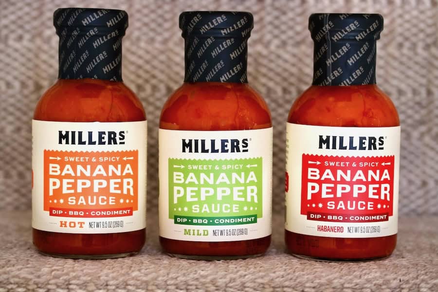 Three bottles of pepper sauce.