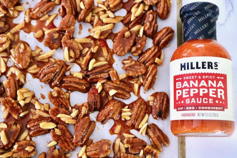Mixed nuts ready to bake and pepper sauce.