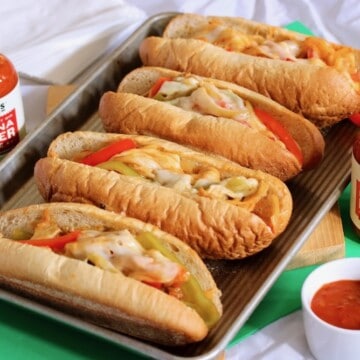 Chicken cheese steak sandwiches with pepper sauce.