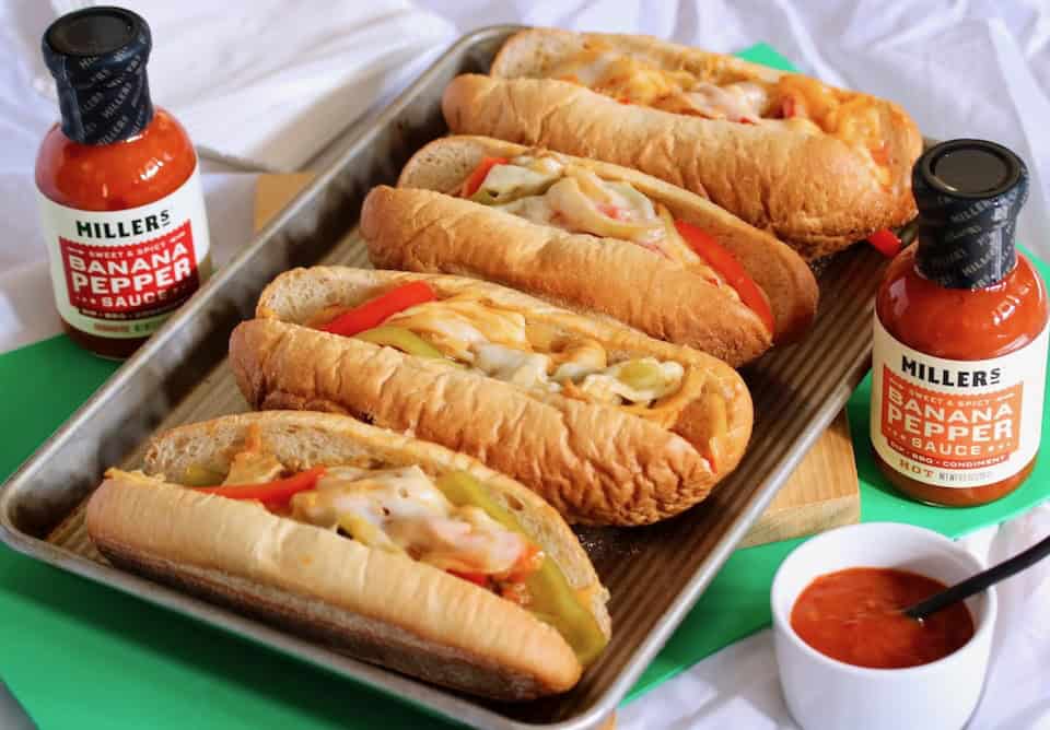 Chicken cheese steak sandwiches with pepper sauce.