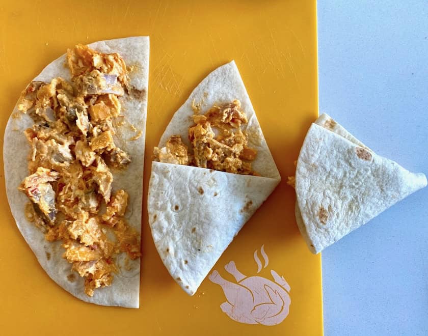 Forming chicken quesadilla appetizer triangles.