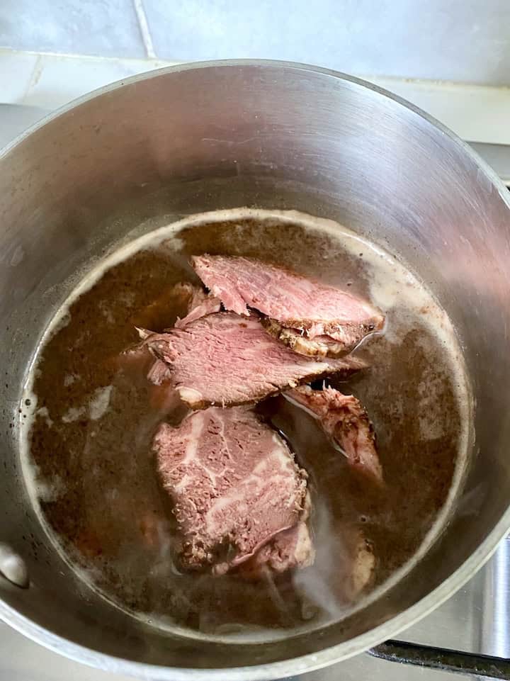 Reheat roast beef in au jus.