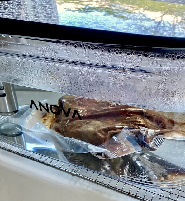 Vacuum sealed chuck roast in water bath.