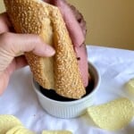 Dipping a sandwich with chips on the side.