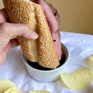 Dipping a sandwich with chips on the side.