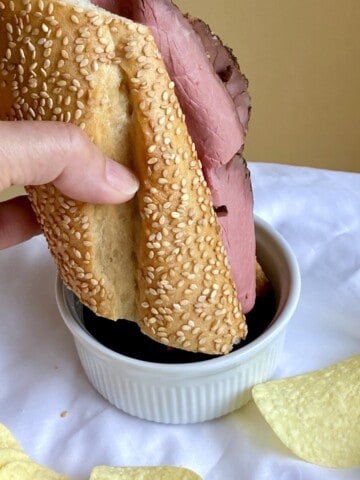 Dipping a sandwich with chips on the side.