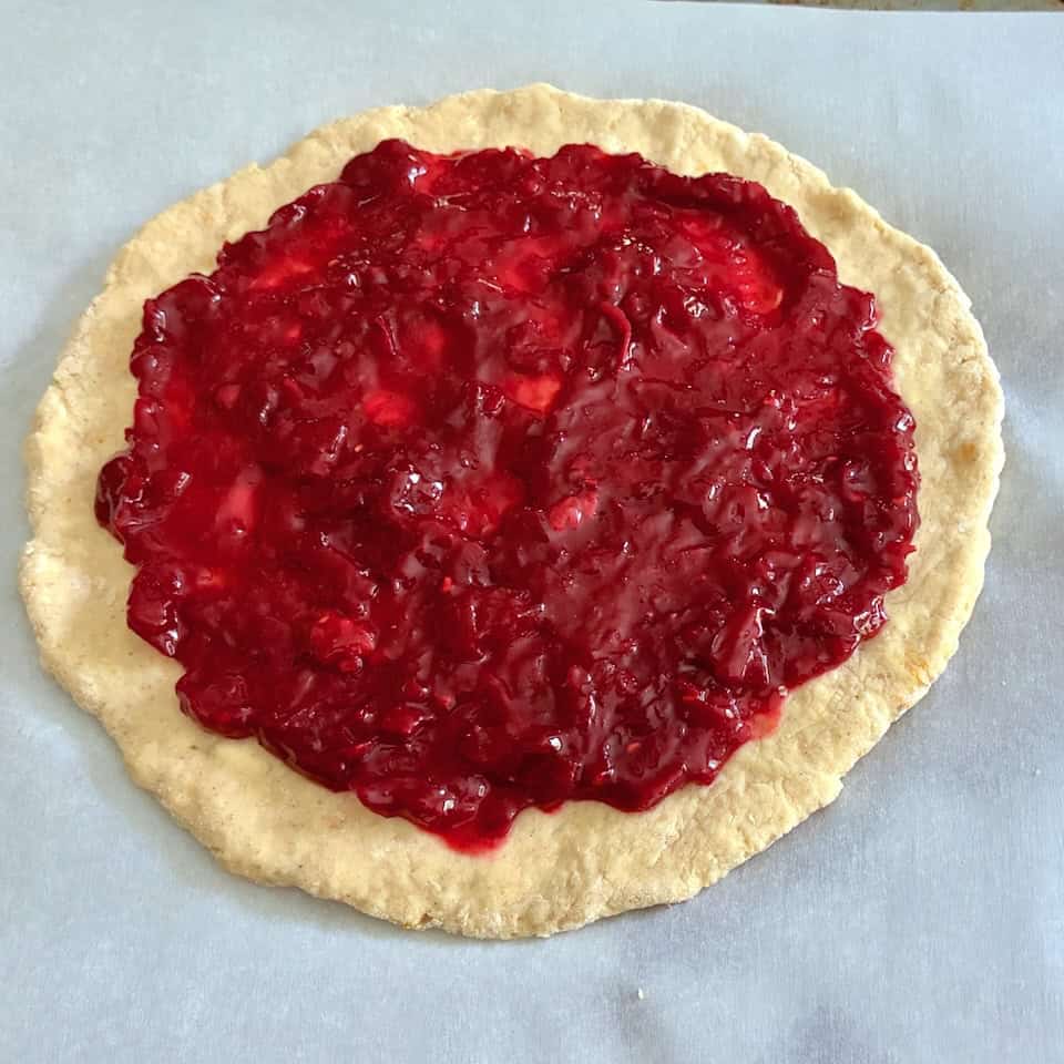 Jam spread over dough.