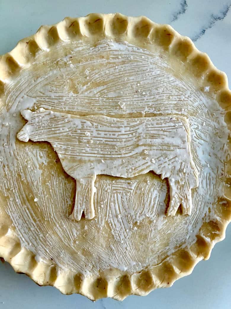 Cow cookie cutter designed pie crust, brushed with cream and sprinkled with flaky salt.