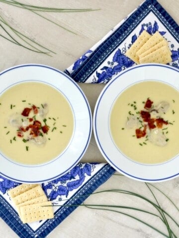Oyster soup recipe topped with bacon and chives.