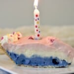 Slice of birthday pie with a candle.