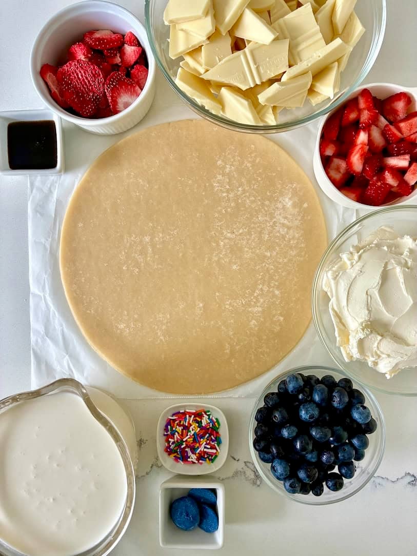 Ingredients for strawberry, blueberry, white chocolate cream cheese mousse birthday pie.