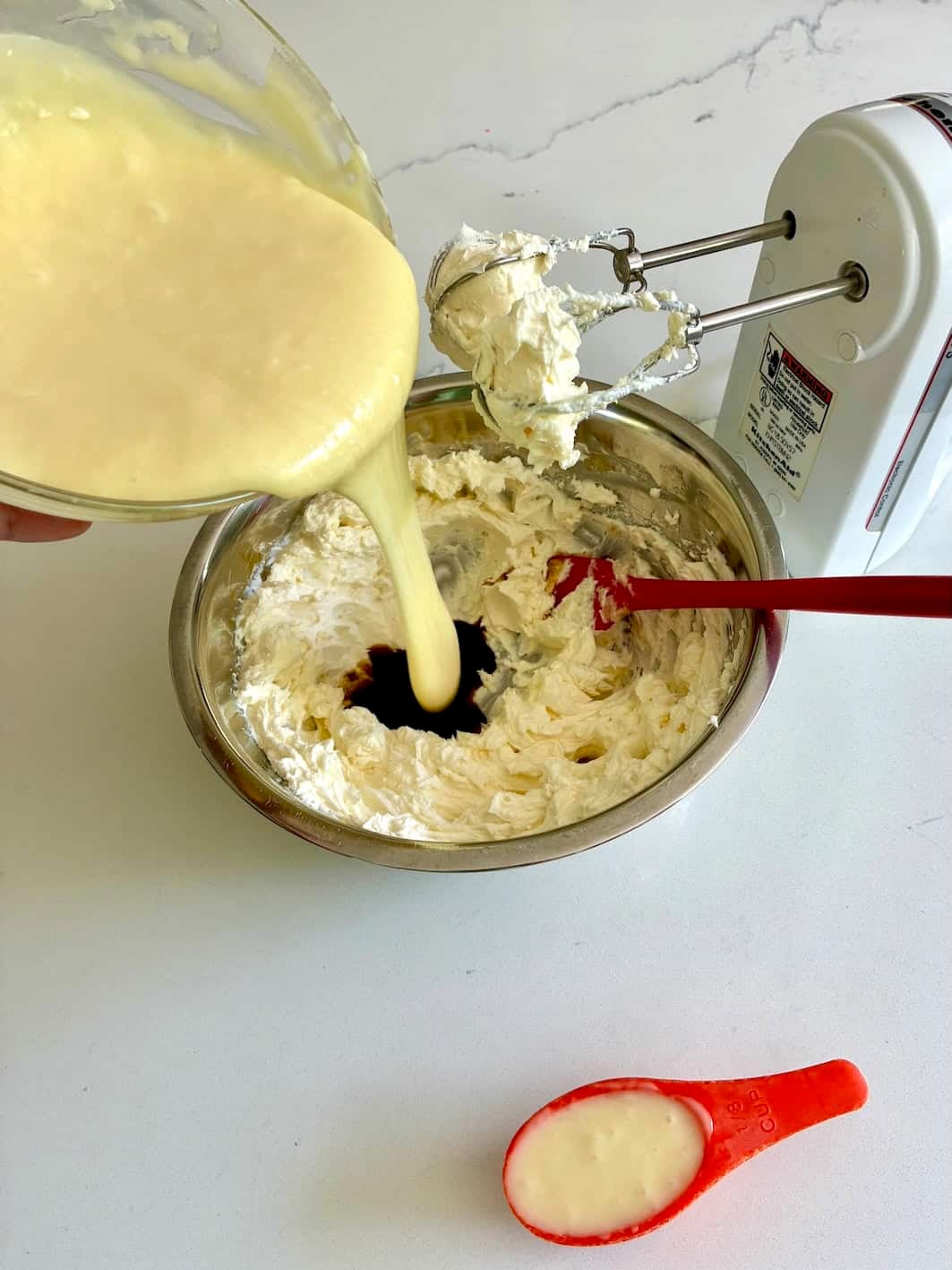 Mixing white chocolate mousse ingredients.