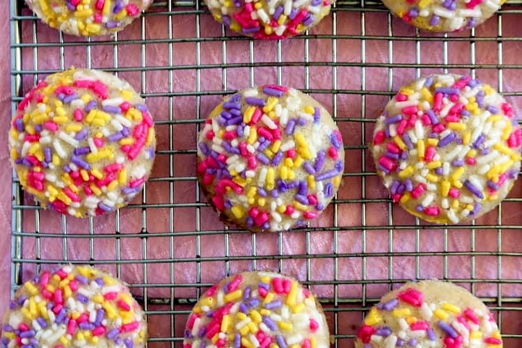 Sprinkles sugar cookies on cooling rack.