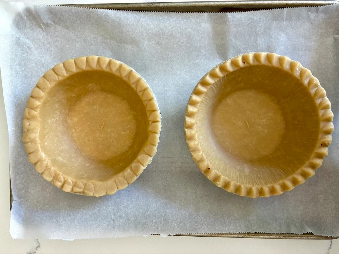 Two pie shells ready to bake.