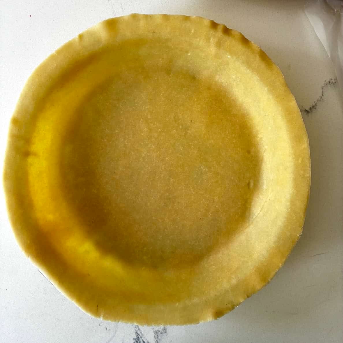 Fitting dough into pie plate.