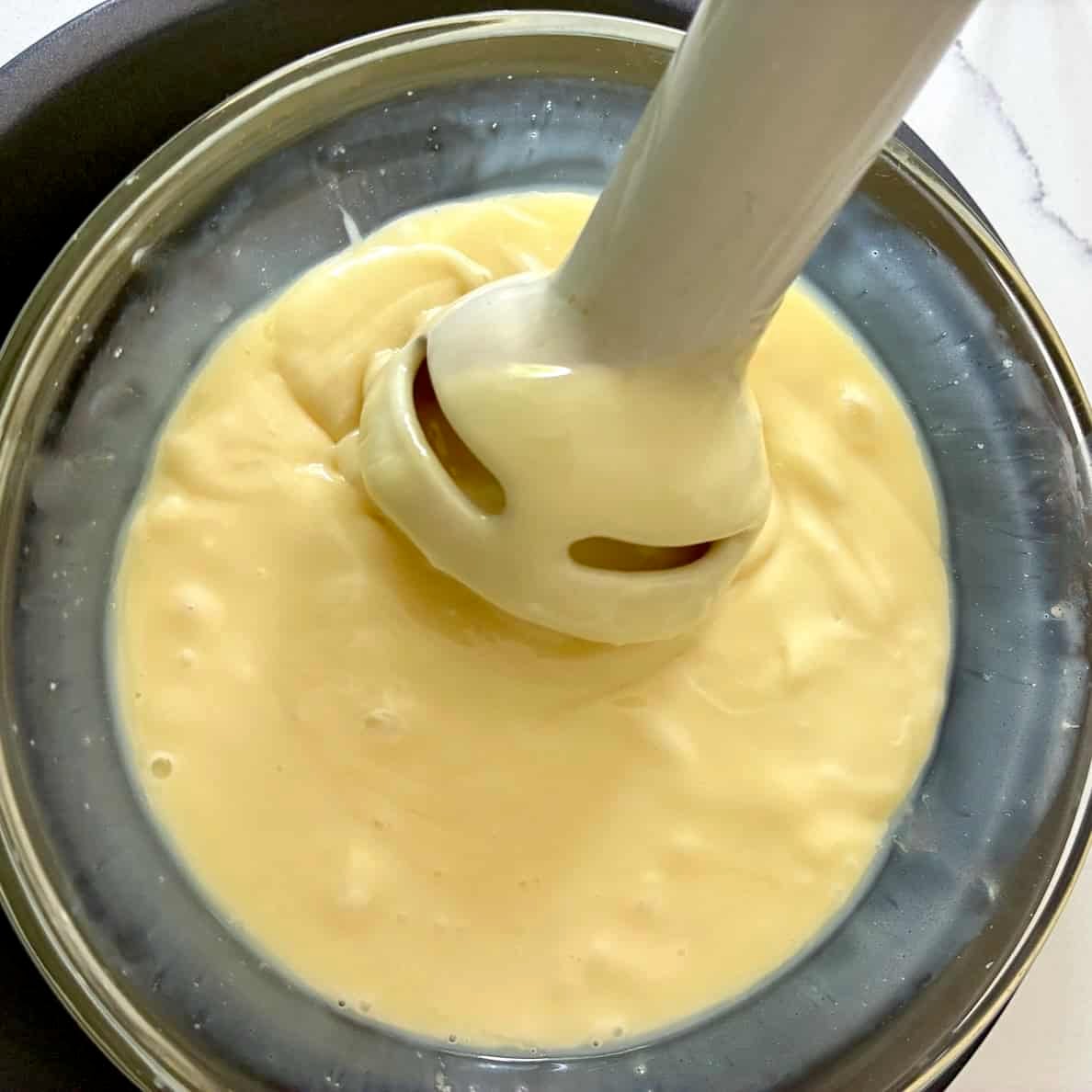Immersion blender in white chocolate ganache.