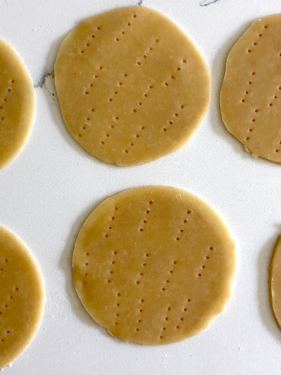 Docked pie dough circles.