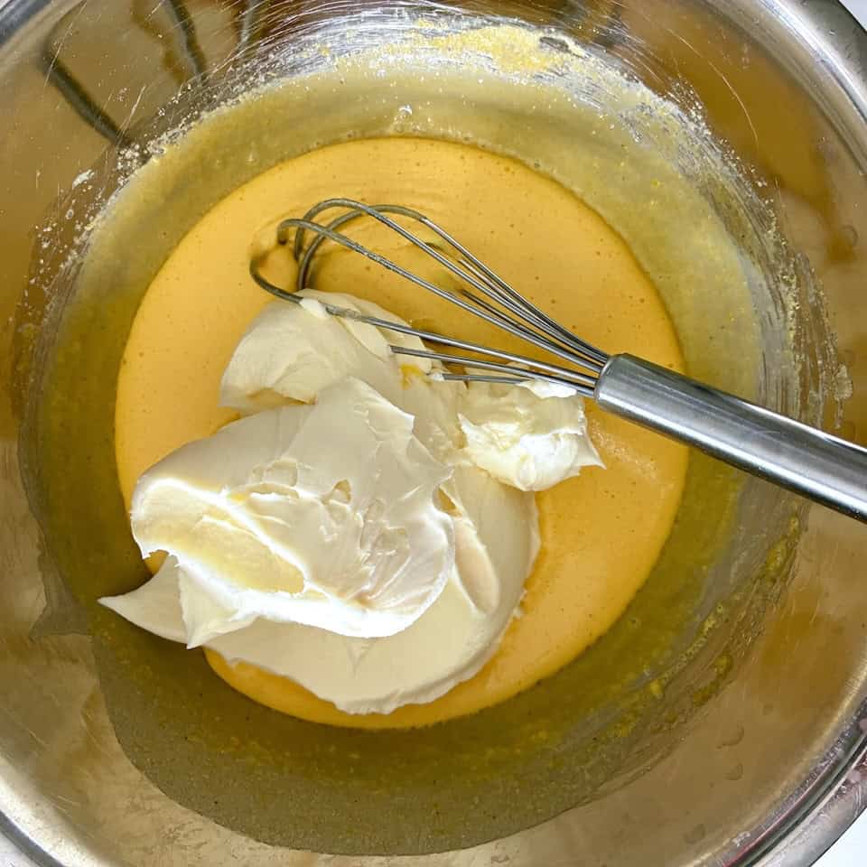 Whisking mascarpone into custard.