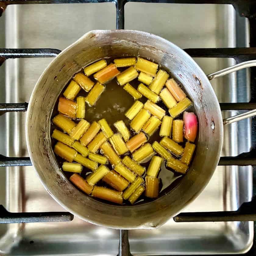 Making rhubarb syrup on the stove.