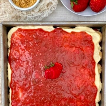Strawberry rhubarb icebox cake with orange crumbs and fresh strawberries.
