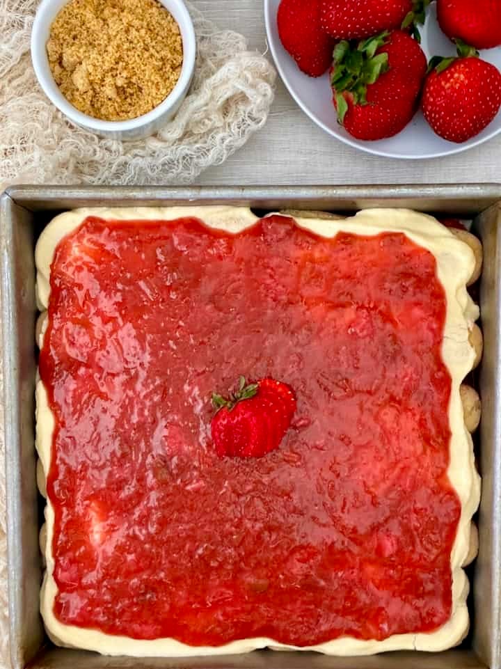 Strawberry rhubarb icebox cake with orange crumbs and fresh strawberries.