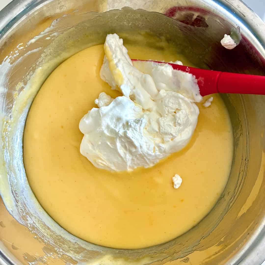 Folding in whipped cream.